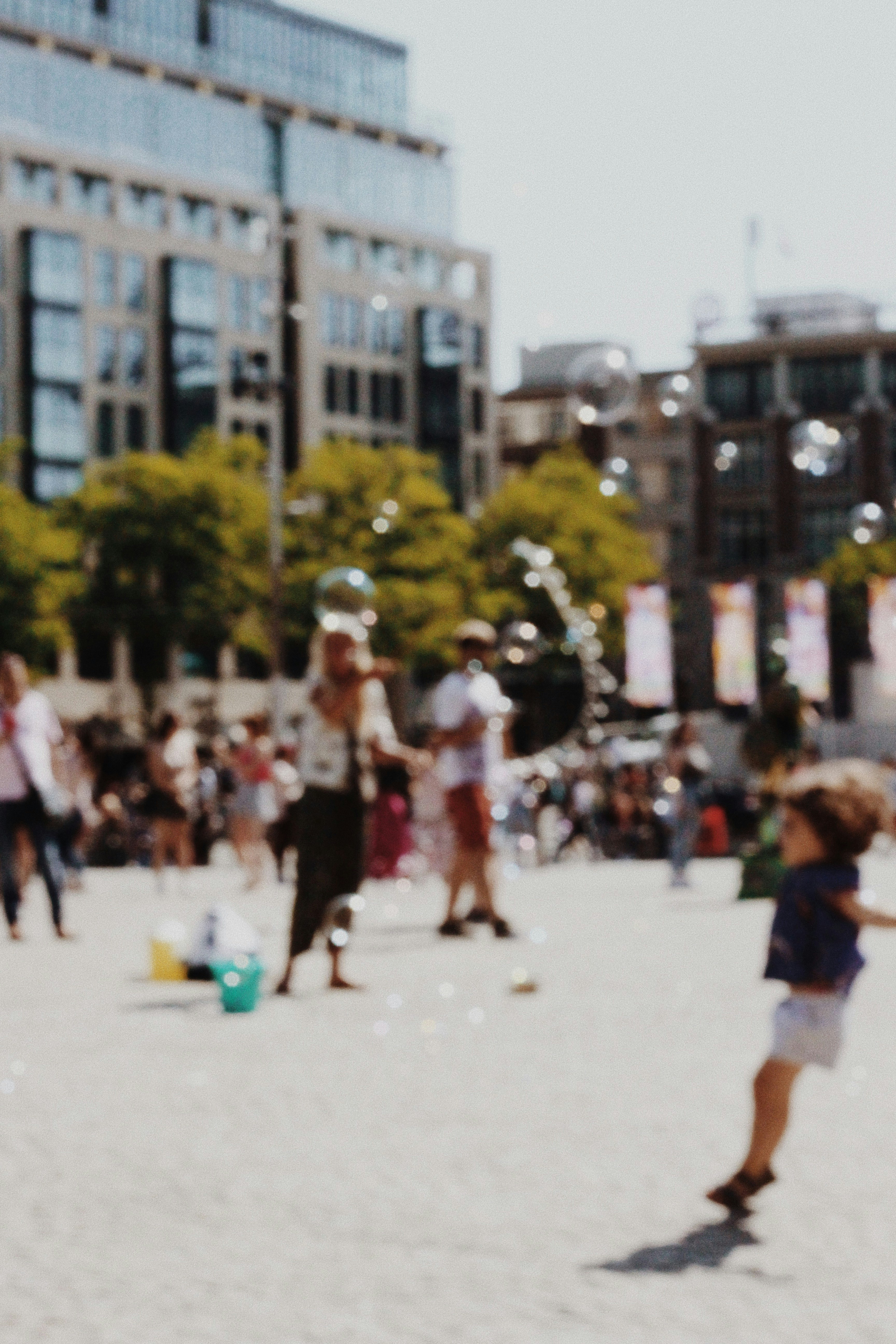 blurry photography of people in a plaza